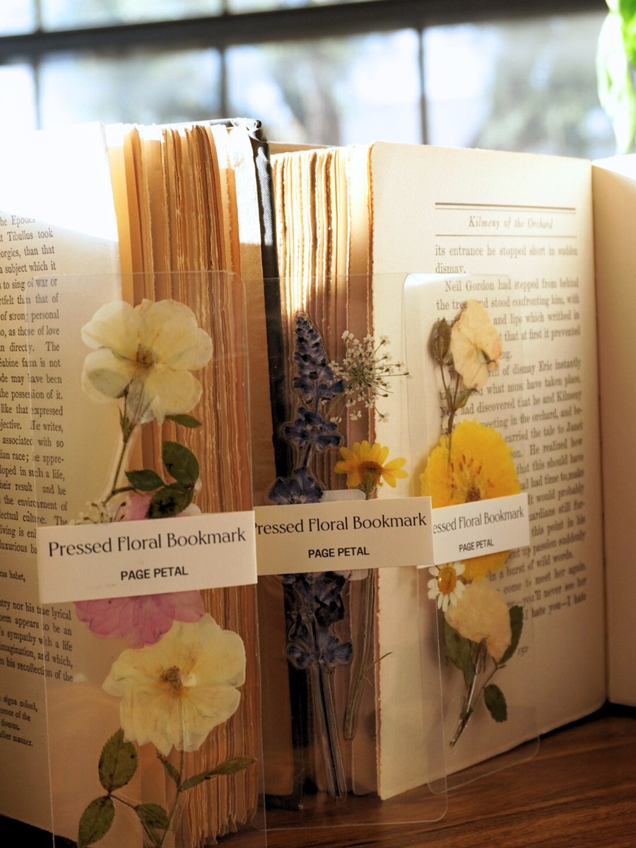 Pressed floral bookmarks tucked into vintage books